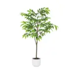 Tropische kunstplant in witte pot